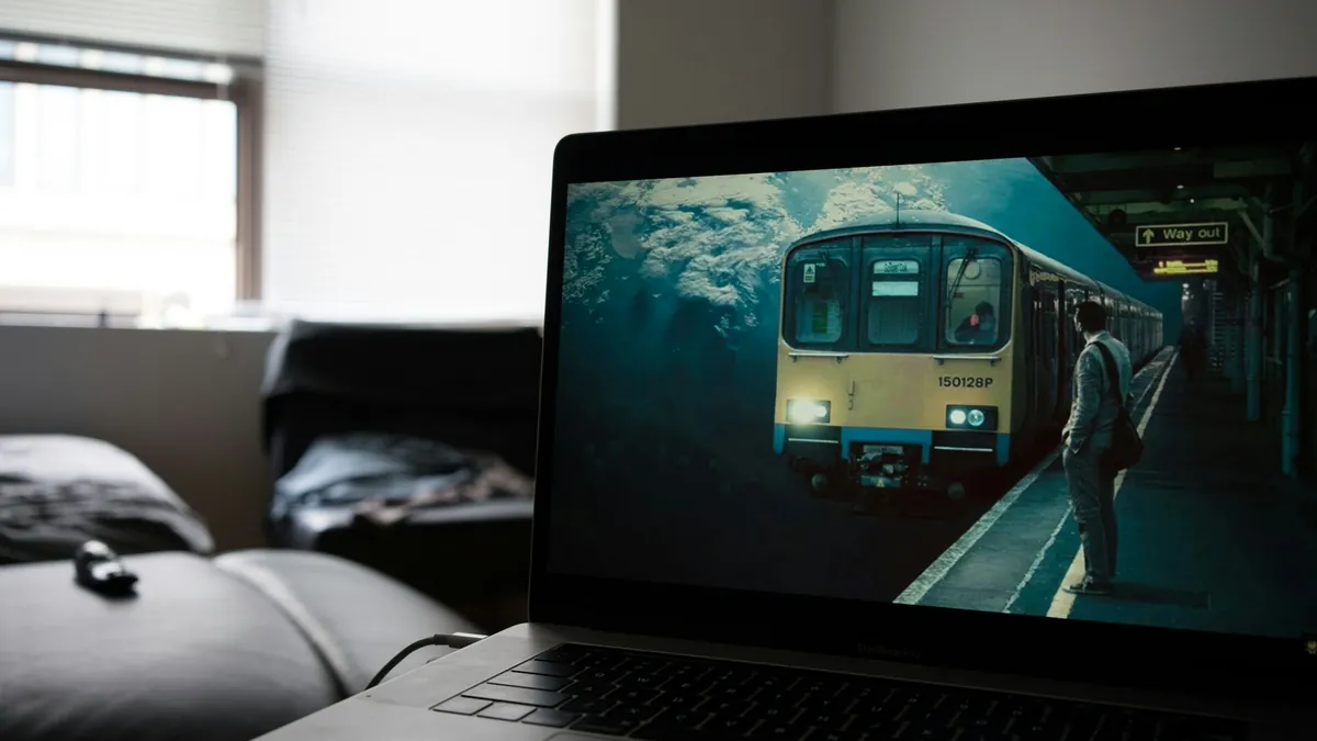 Laptop on a sofa playing a film, showing how IPTV on Windows or Mac works at home in New Zealand