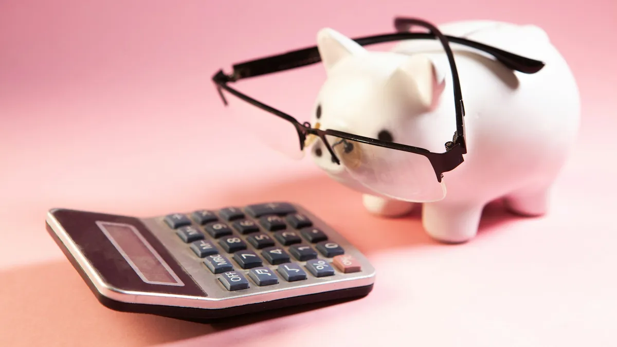 Piggy bank and calculator, working out whether a lifetime IPTV plan is worth it