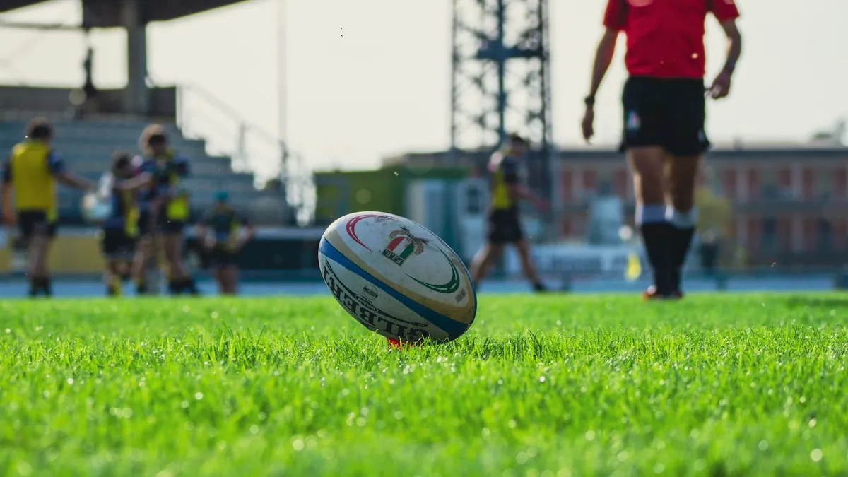 Rugby ball on a kicking tee on a green field, watching sport on IPTV in New Zealand
